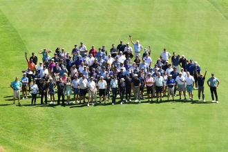 Golf classic participants pose for a group photo. 